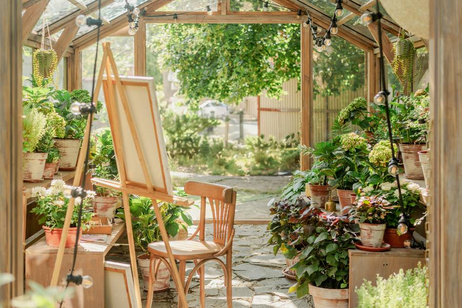 Cozy garden chair setup with pillows beside blooming flowers