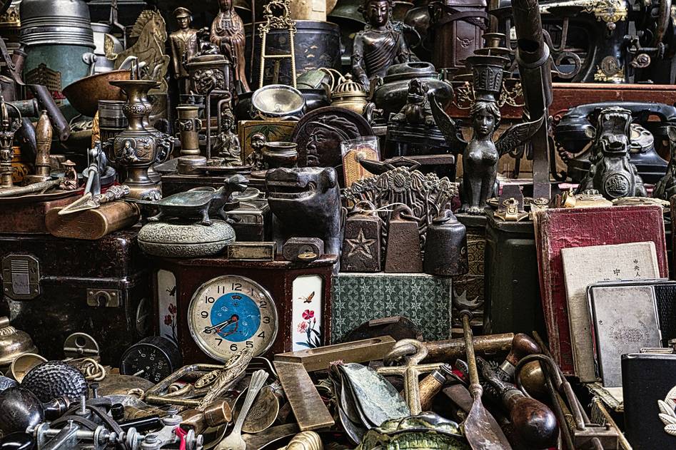 Antique writing desk with old ledgers, a magnifying glass, and vintage keys