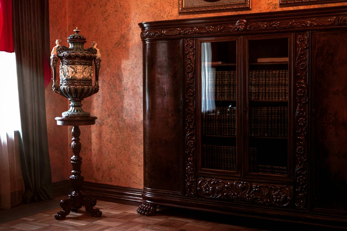 antique estate broker inspecting vintage furniture at an estate auction