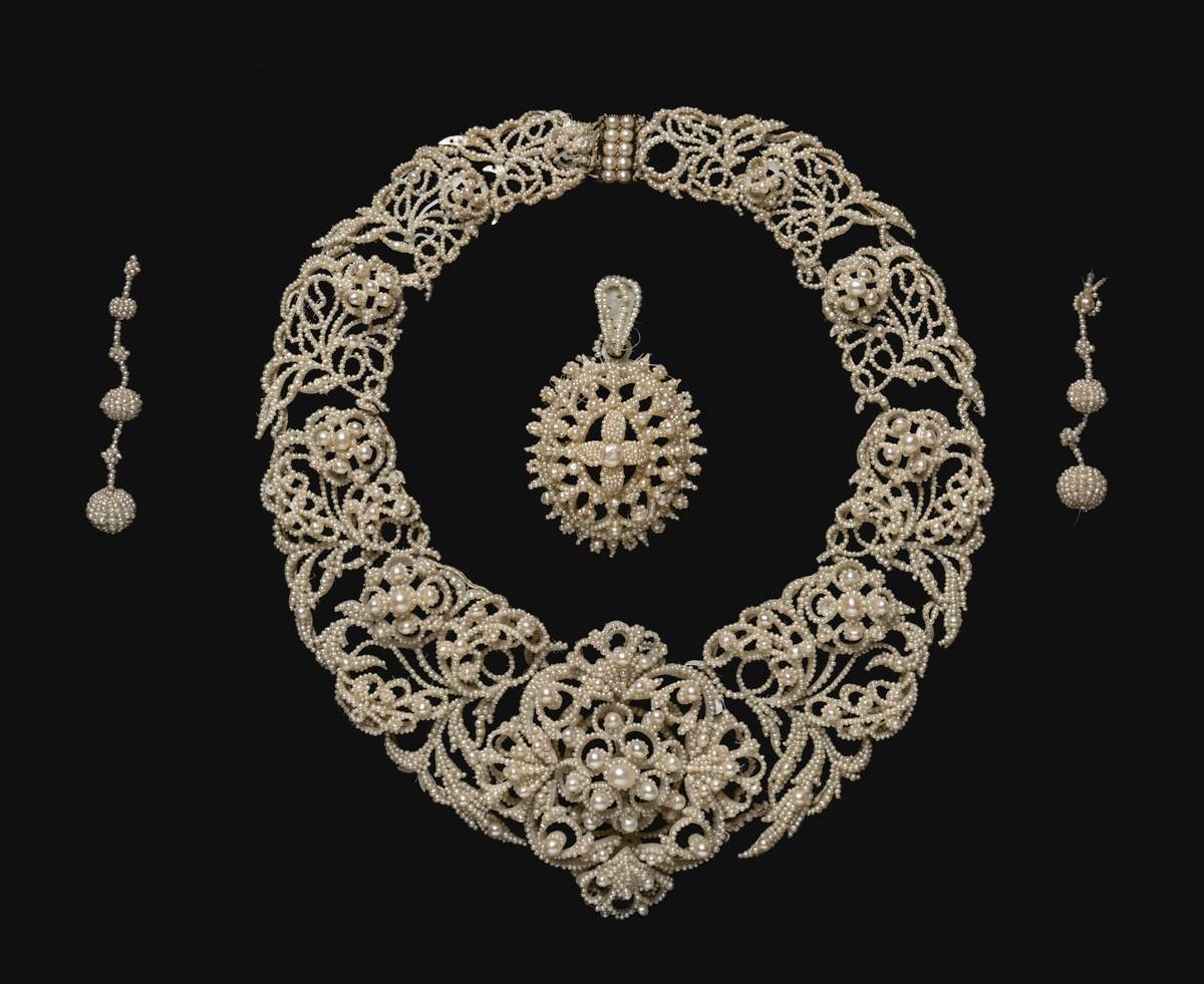 Close-up of lang antique and estate jewelry featuring an Art Deco diamond ring on velvet