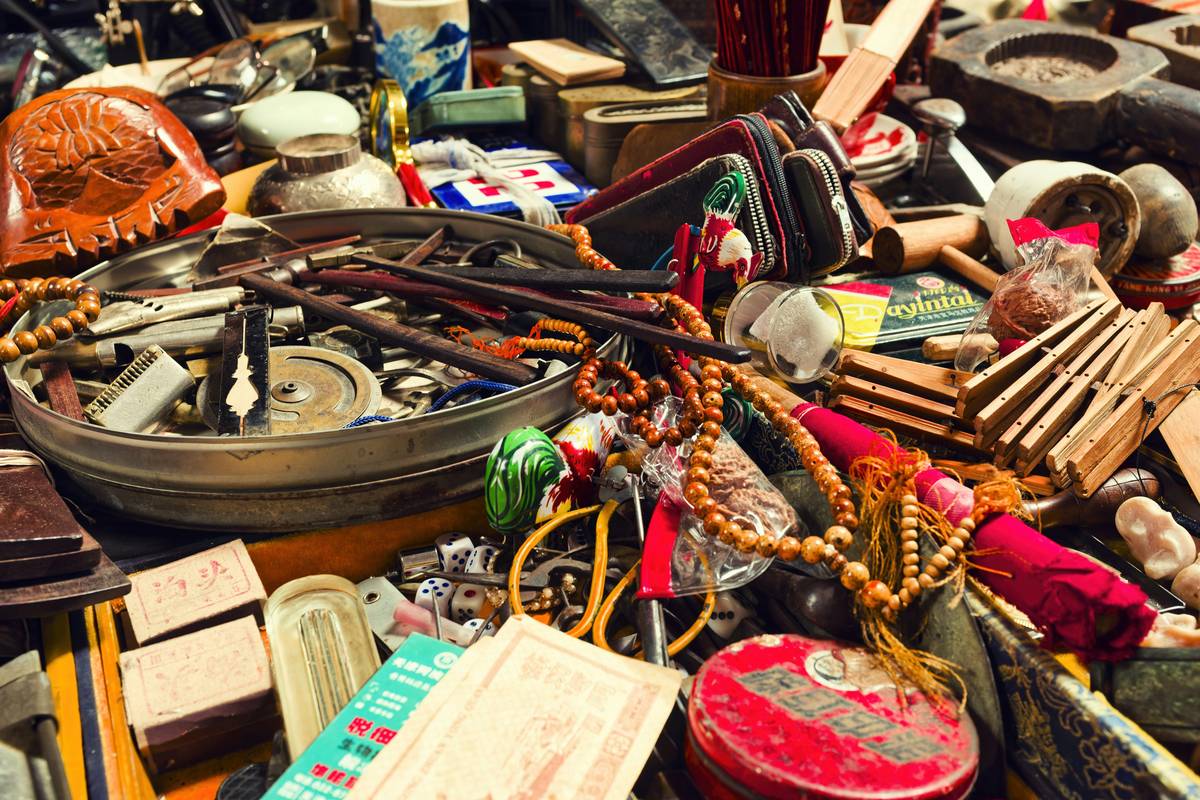 Wooden secretary desk labeled as antique at estate auction—illustrating what makes an antique an antique