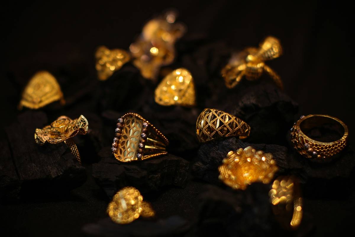 Close-up of estate and vintage jewelry displayed on velvet, showing intricate filigree and mixed gemstones
