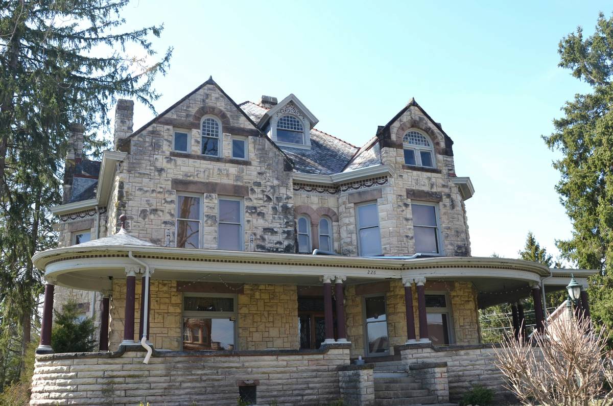 old estate house interior filled with vintage furniture and boxes awaiting auction